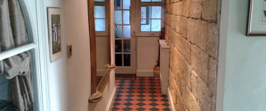 Hallway with exposed stone wall at Thorpe Green House