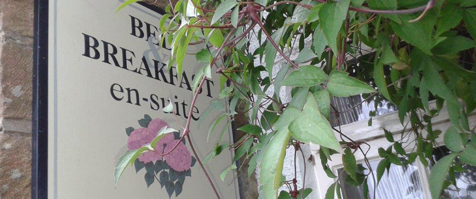 Thorpe Green House bed and breakfast sign behind greenery